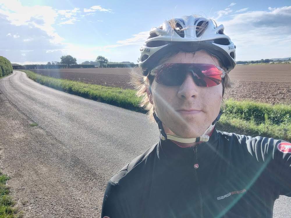 Calum in cycle gear on winding country lane