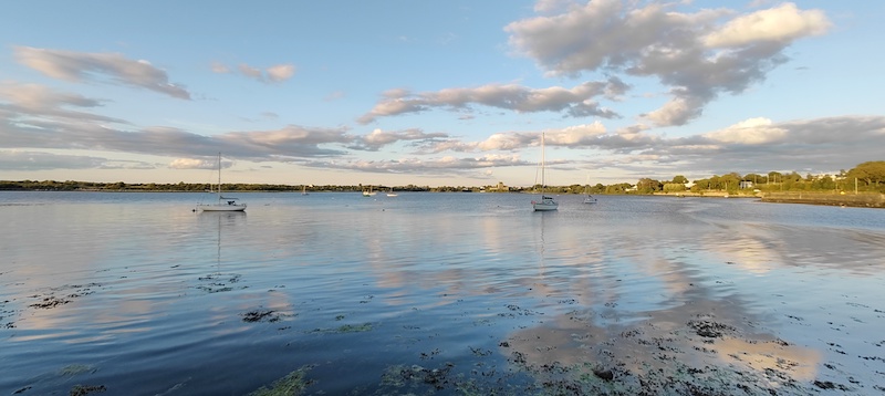 View Kinvarra castle, boats and sunset over loch