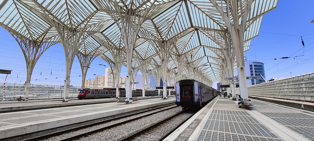 Inside view of Oriente train station with two trains on platforms