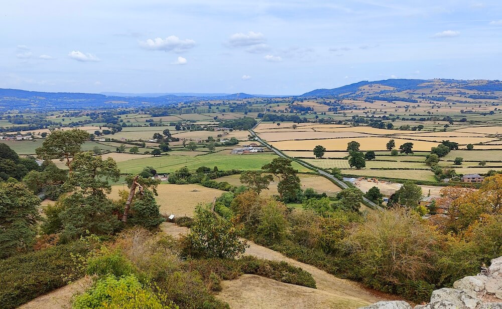 High-up view of countryside and hills in backdrop