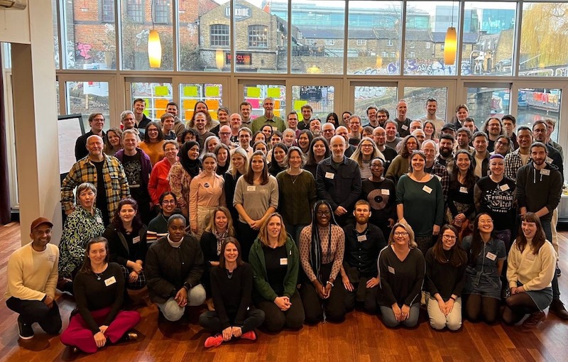 team of 100+ people with backdrop of Camden Lock