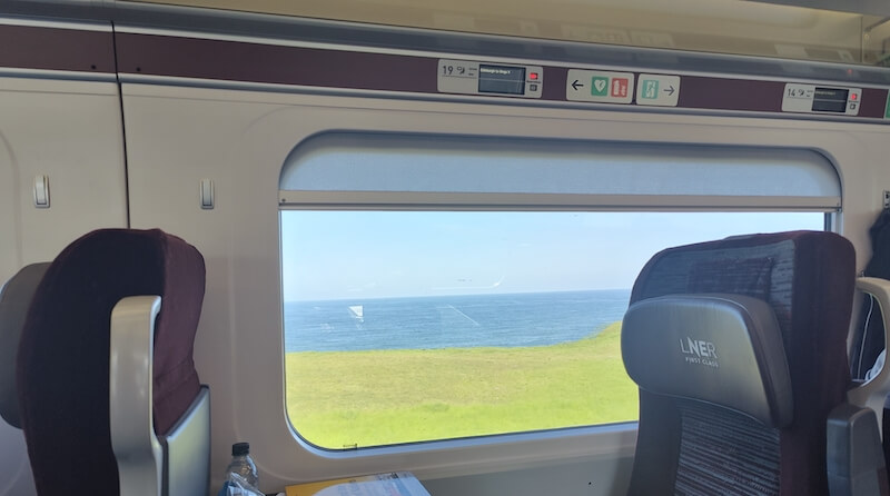 View from train window of coastline