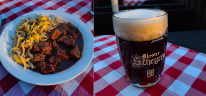 beef goulash accompanied by butter spaetzle and a glass of dark beer