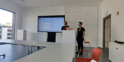 Tantek and Aaron beside a large screen