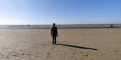 sculpture of human on beach