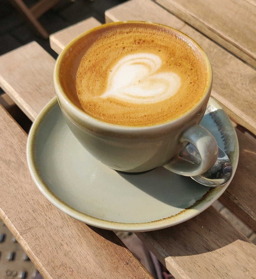 flat white coffee with artwork in heart shape