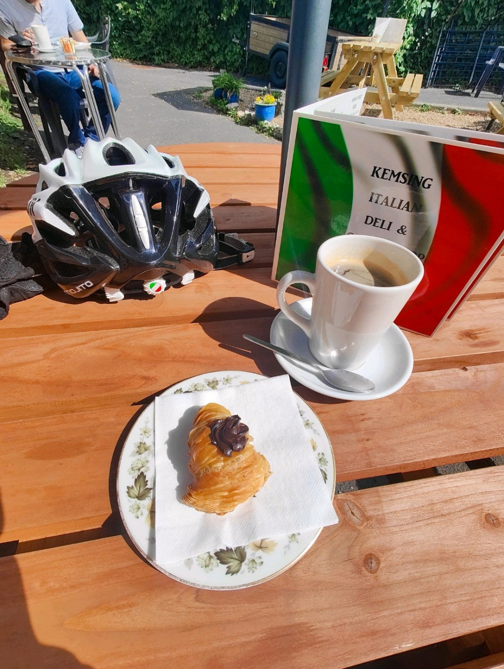 Coffee and pastry on picnic table