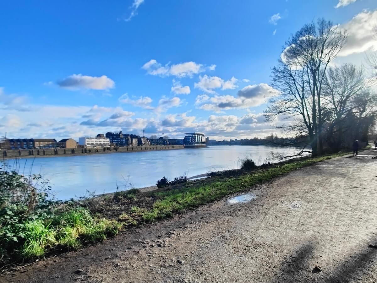 On the banks of the River Thames on a clear winter's day looking towards Fulham Football Stadium