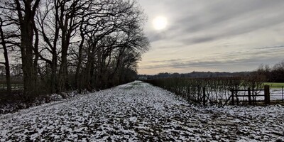 Bridle path near Tonbridge with melting snow and sun peaking through clouds