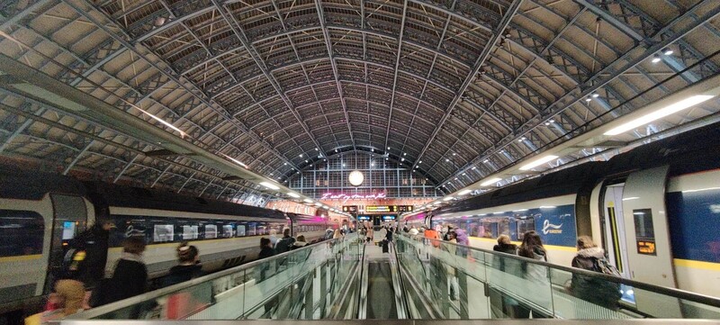Night time London St Pancras terminal shot with two trains and station clock