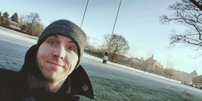 Calum headshot with backdrop of Tonbridge School rugby pitch on frosty day