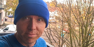 It's me wearing a blue beanie and blue jumper with the backdrop of the balcony