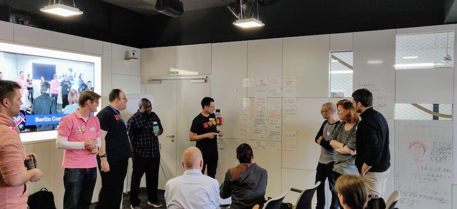 Attendees doing session planning for IndieWebCamp inside Mozilla Berlin offices