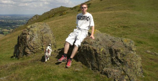 Calum on Caer Caradoc in the Shropshire Hills with his dog Berthe