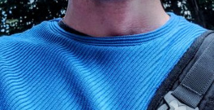 Calum wearing a blue jumper outside in London