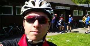 Calum in cycling wear outside Ide Hill village hall
