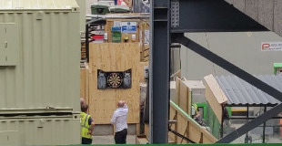 Crossrail construction site at Moorgate with men playing darts