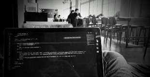 Coding on a laptop screen inside at Mozilla Berlin